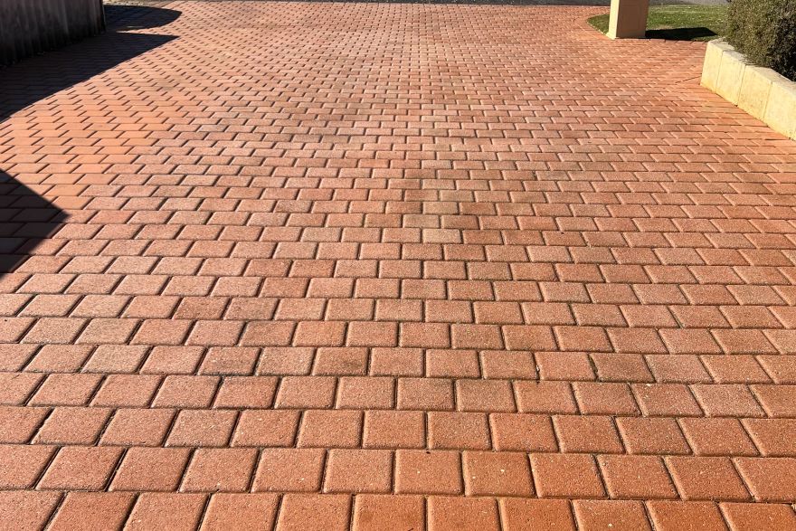 Organic growth removed from brick paving: after