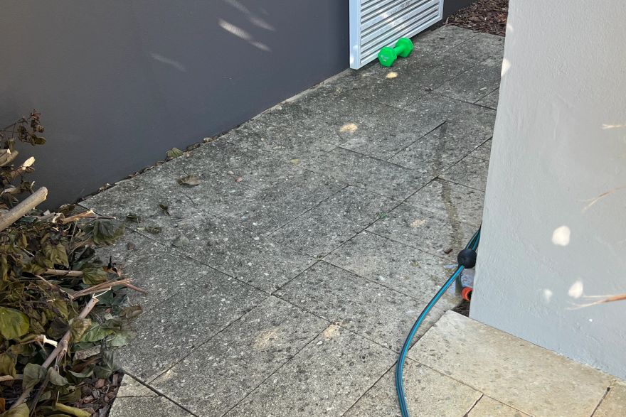 Stone paving beside the house: before