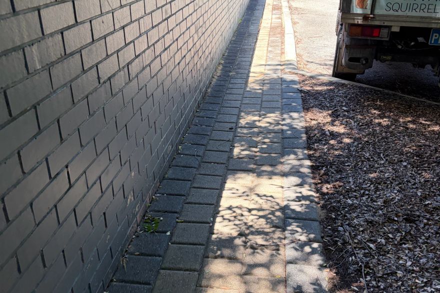 Before and after cleaning on brick pavers: before