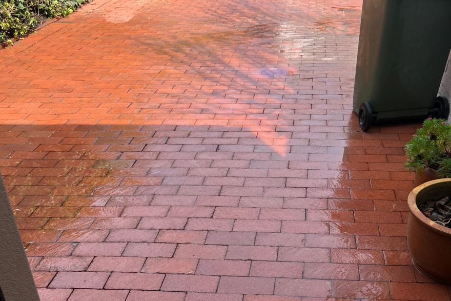 Before and after cleaning on brick pavers · Driveway: after