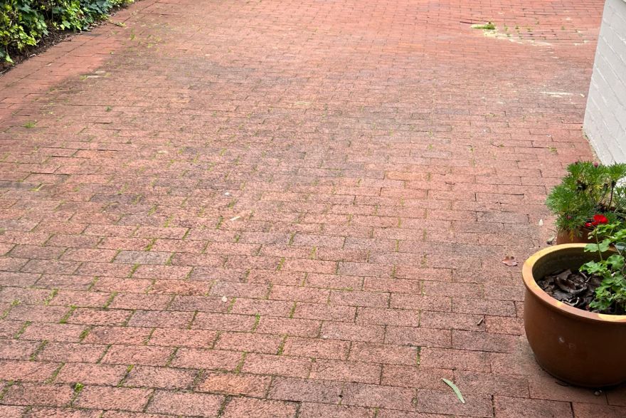 Before and after cleaning on brick pavers · Driveway: before