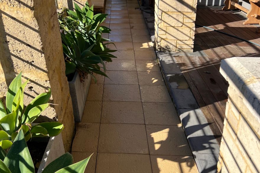 Before and after cleaning on sandstone pavers · Path: after