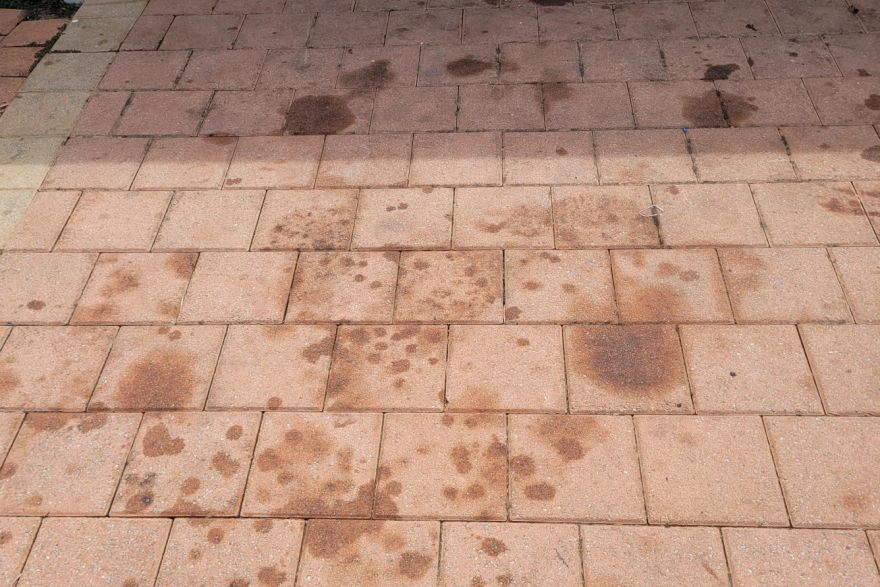 Before and after oil stains on brick pavers · Driveway: before