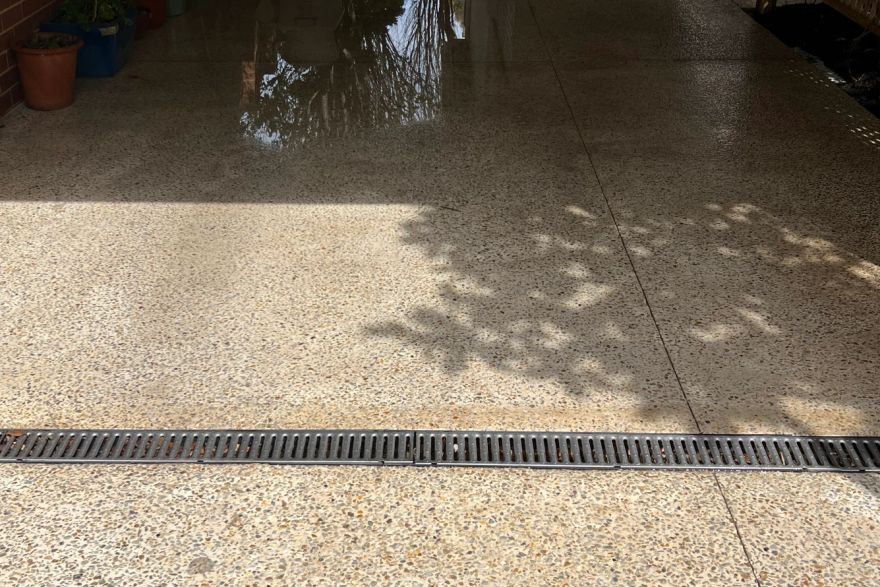 Before and after cleaning on concrete exposed aggregate · Garage floor: after