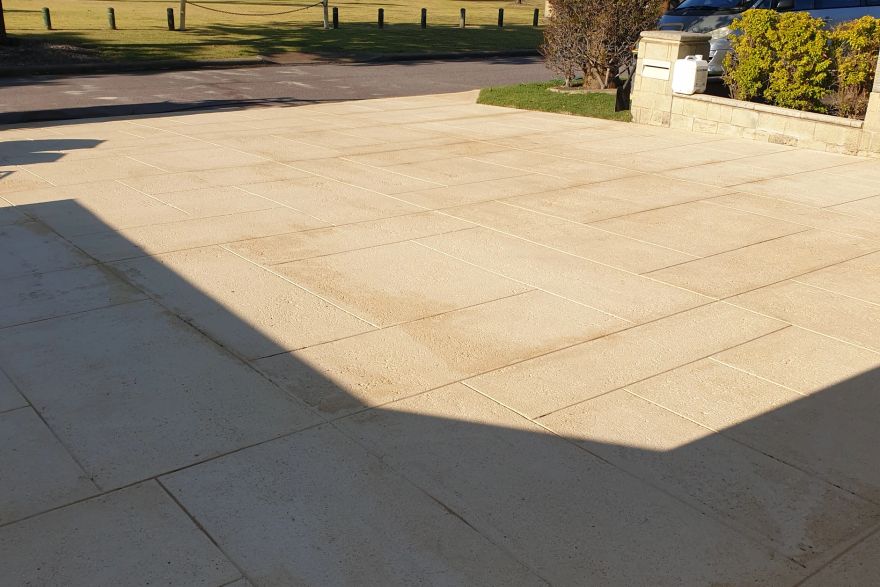 Before and after cleaning on liquid limestone · Driveway: after