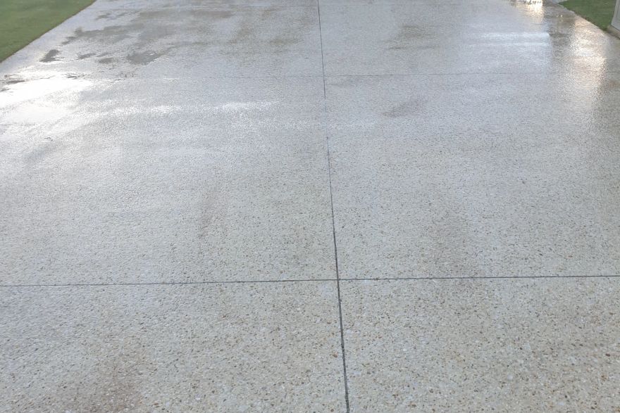 Before and after cleaning on concrete exposed aggregate · Driveway: after