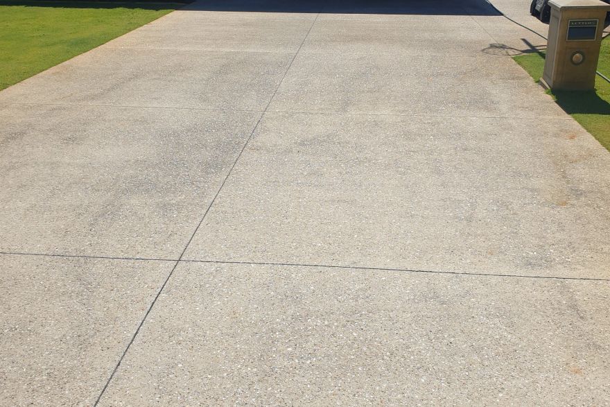 Before and after cleaning on concrete exposed aggregate · Driveway: before