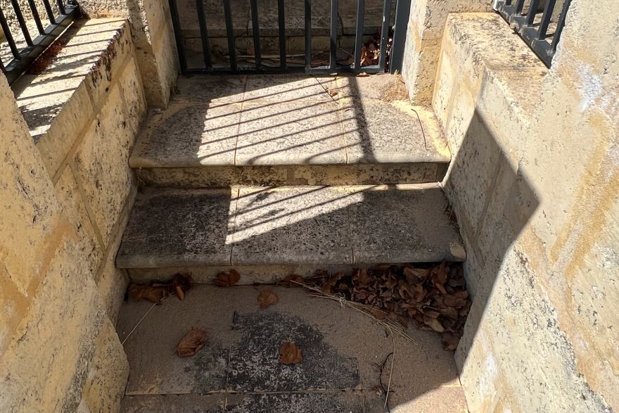 Before and after cleaning on sandstone pavers: before