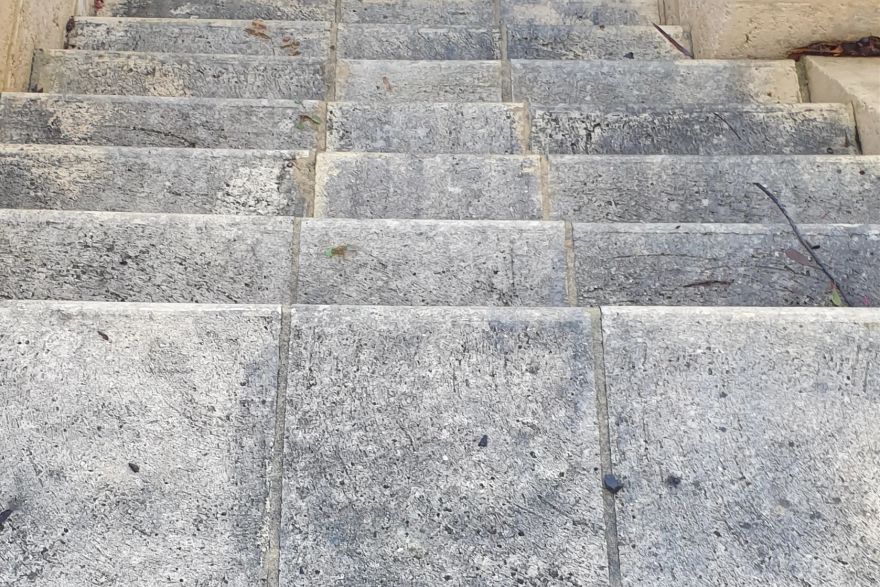 Before and after cleaning on sandstone pavers: before