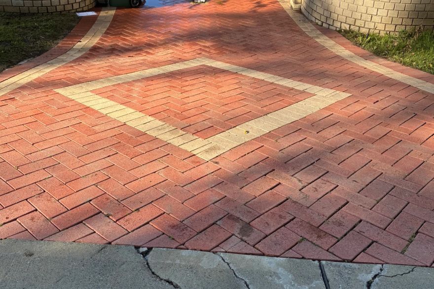 Before and after cleaning on brick pavers · Driveway: after