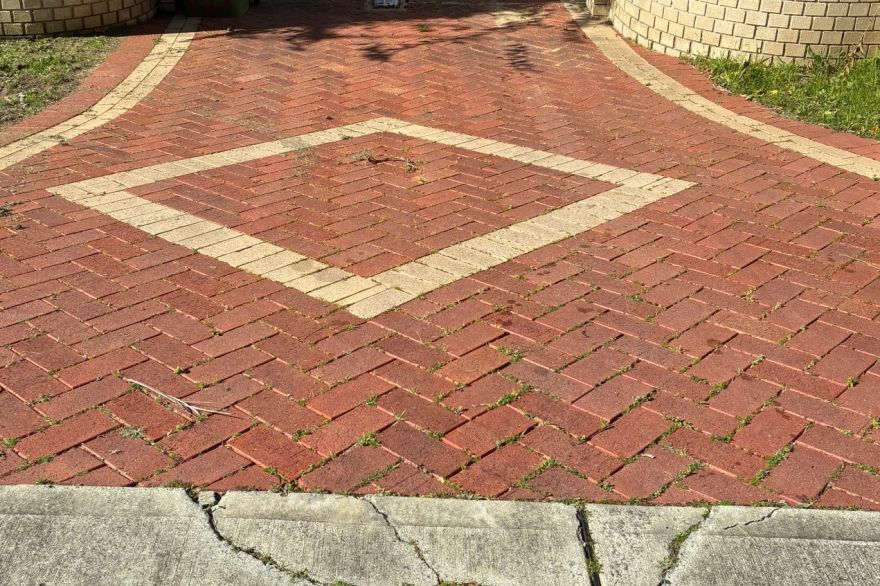 Before and after cleaning on brick pavers · Driveway: before