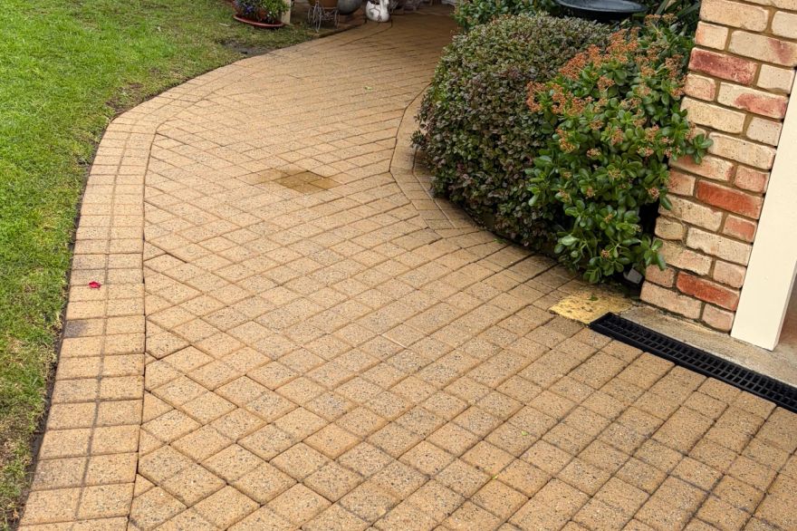 Before and after cleaning on brick pavers · Path: after