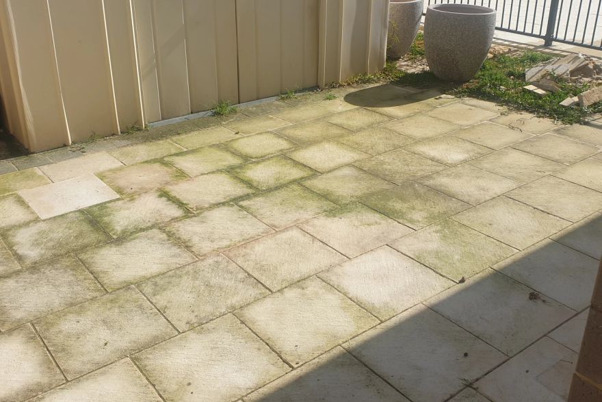 Before and after cleaning on sandstone pavers: before
