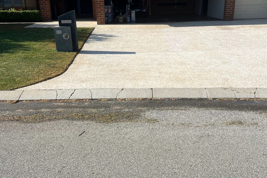 Before and after rust / bore stains on concrete exposed aggregate · Driveway: after