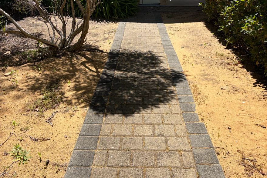 Before and after cleaning on brick pavers: before