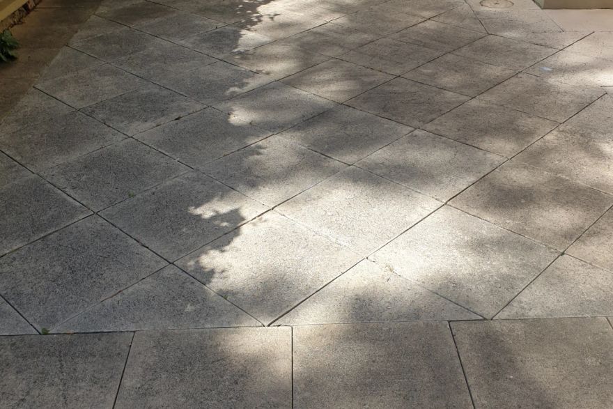 Before and after cleaning on sandstone pavers: before