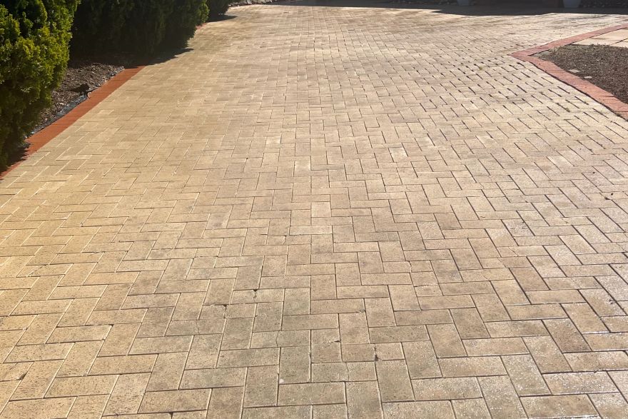 Before and after cleaning on brick pavers · Driveway: after