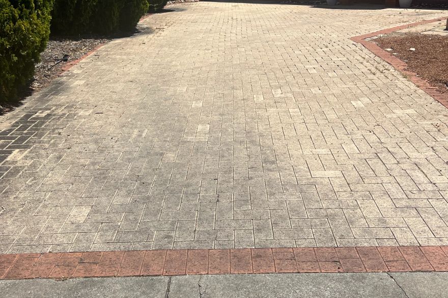 Before and after cleaning on brick pavers · Driveway: before