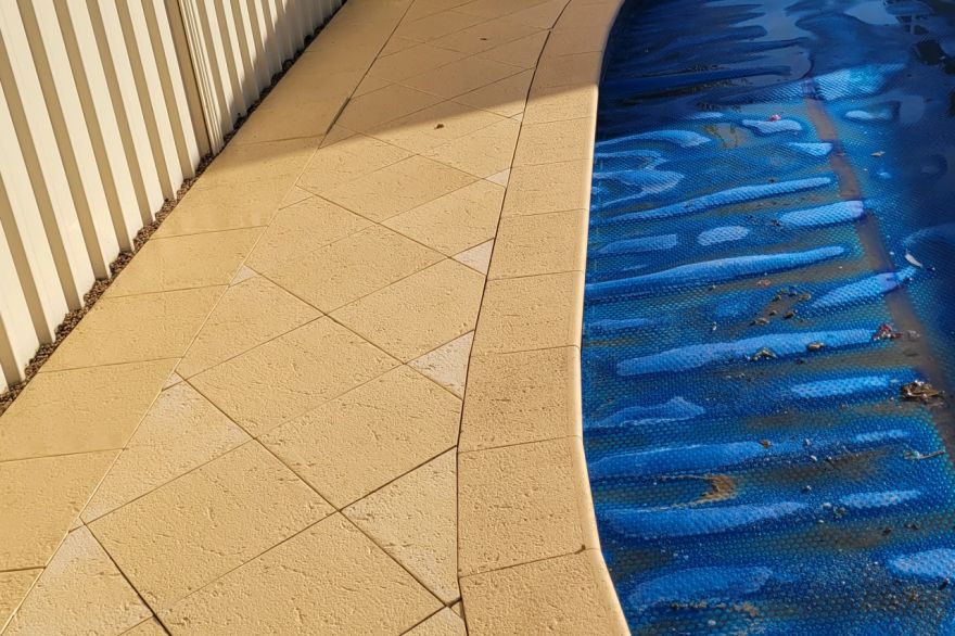 Before and after cleaning on sandstone pavers · Poolside: after