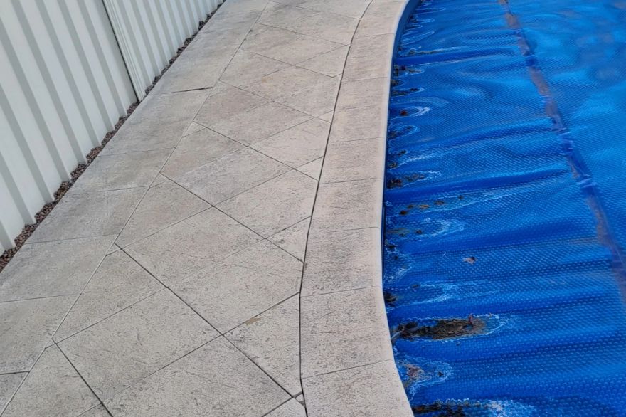 Before and after cleaning on sandstone pavers · Poolside: before