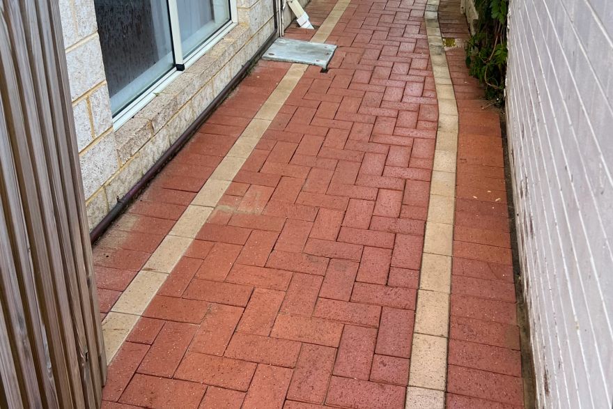 Before and after cleaning on brick pavers · Path: after