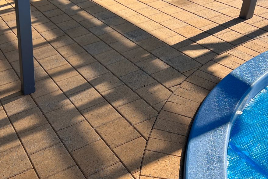 Before and after cleaning on brick pavers · Poolside: after