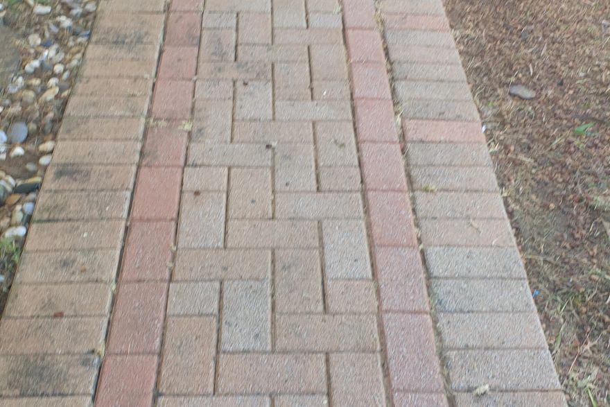 Before and after cleaning on brick pavers · Path: after