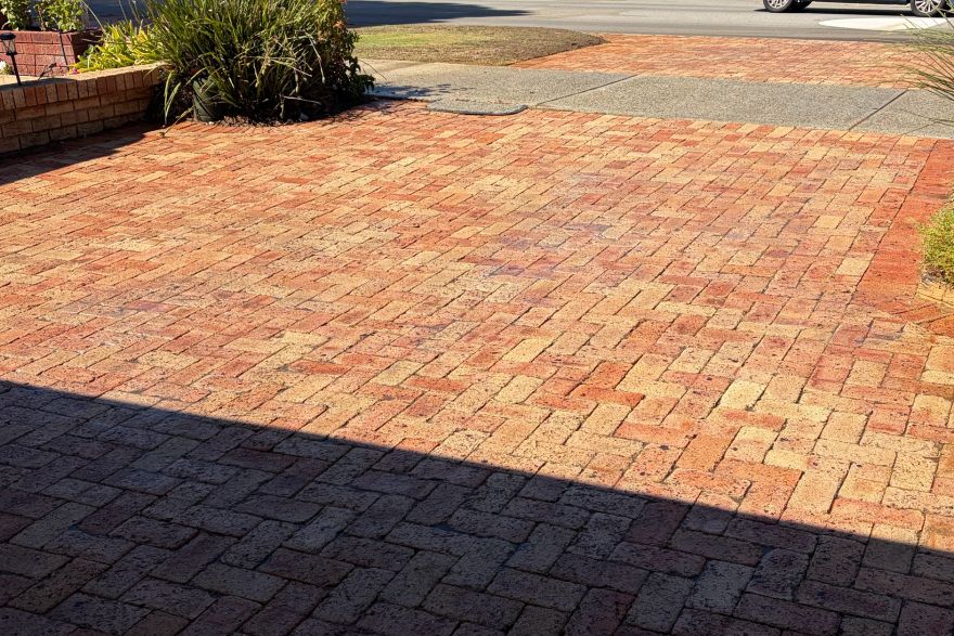 Before and after cleaning on brick pavers · Driveway: after