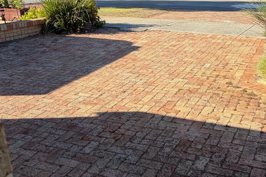 Before and after cleaning on brick pavers · Driveway: before
