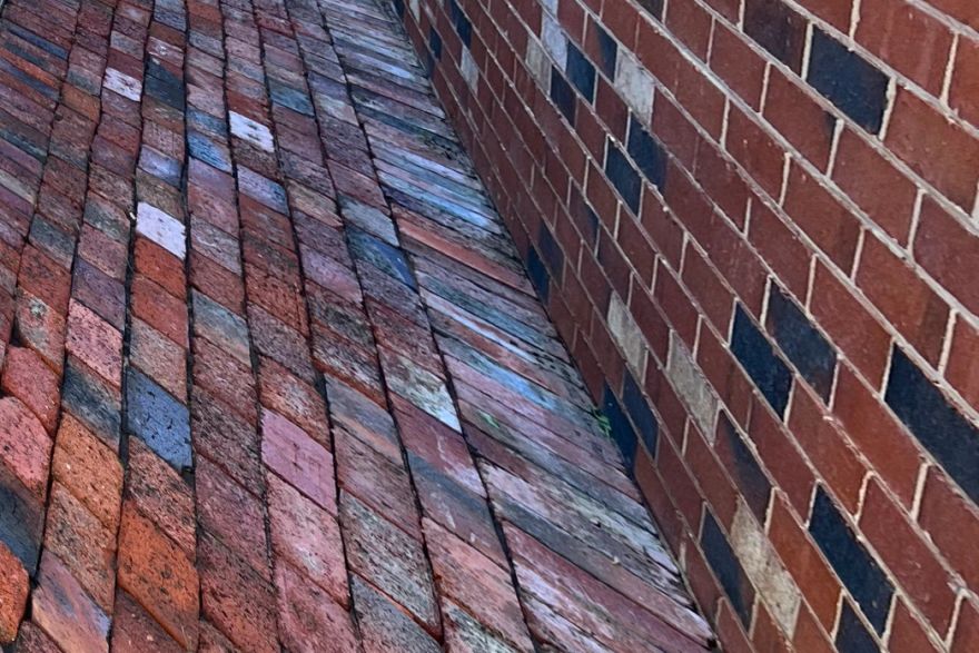 Before and after cleaning on brick pavers · Path: after