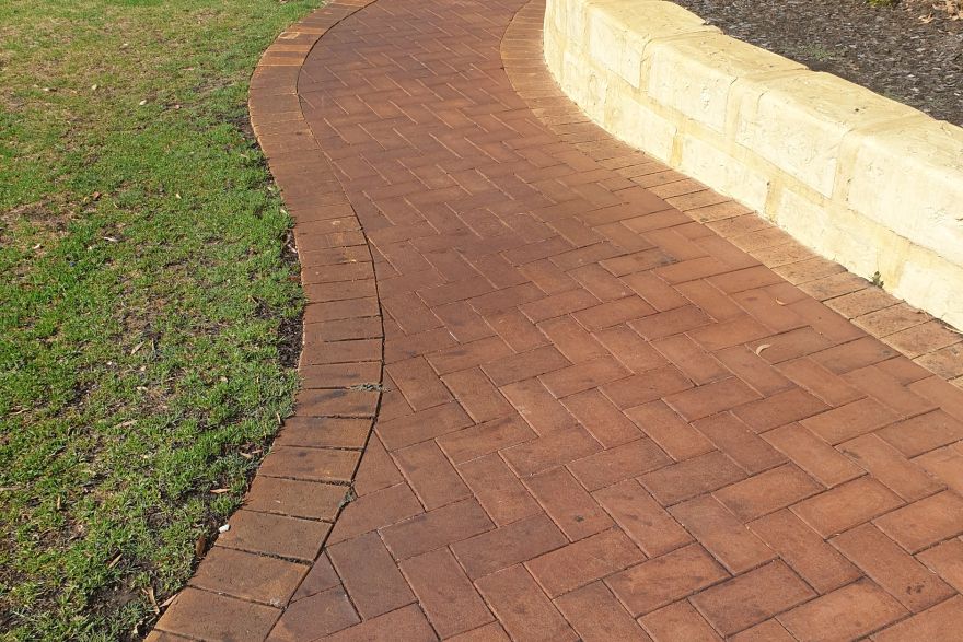 Before and after rust / bore stains on brick pavers: before