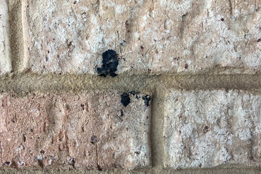 Before and after graffiti on house bricks: before