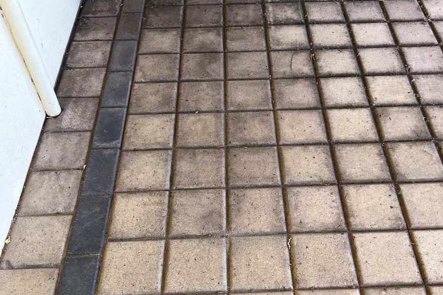 Before and after cleaning on brick pavers: before