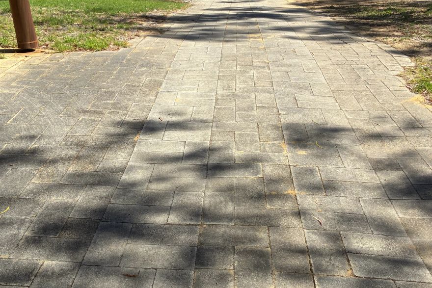 Before and after cleaning on brick pavers: before