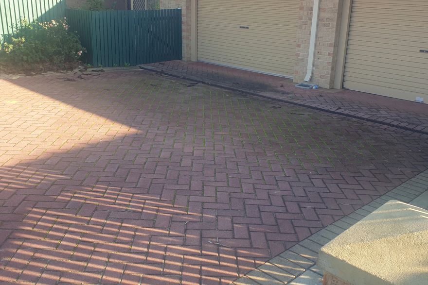 Before and after cleaning on brick pavers · Driveway: before