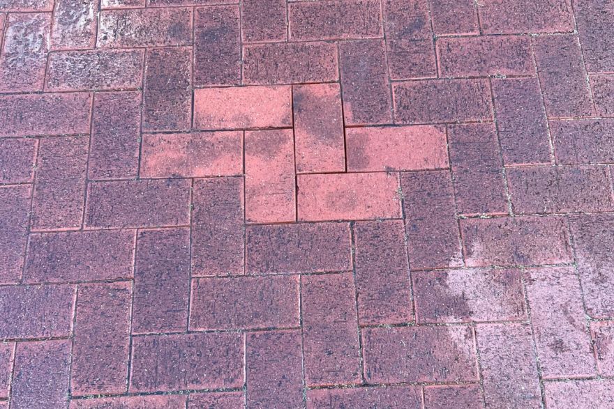 Before and after oil stains on brick pavers · Driveway: after