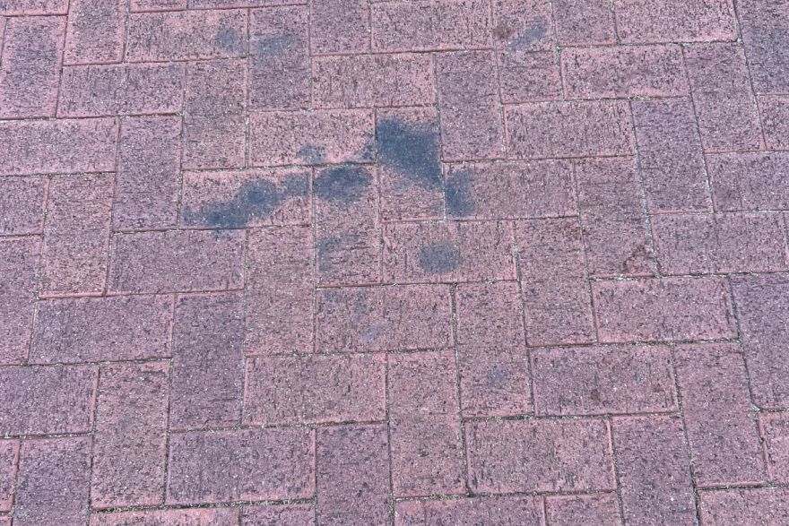 Before and after oil stains on brick pavers · Driveway: before