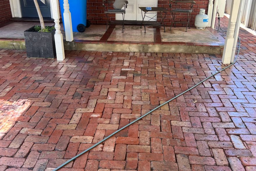 Before and after cleaning on brick pavers · Garage floor: after