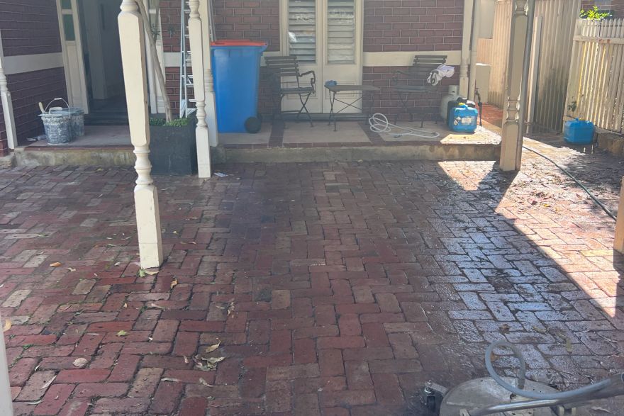 Before and after cleaning on brick pavers · Garage floor: before