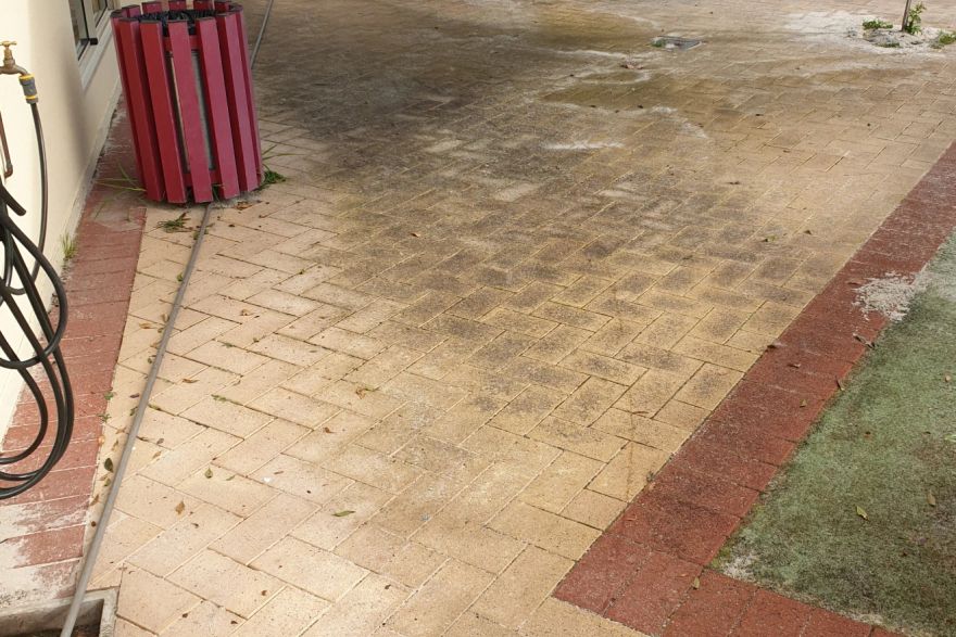 Before and after cleaning on brick pavers: before