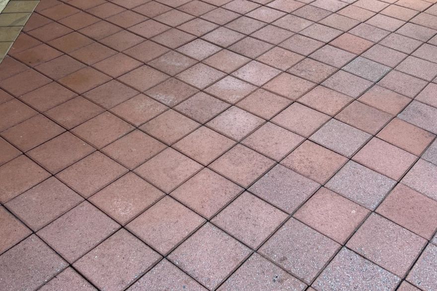 Before and after cleaning on brick pavers · Patio / alfresco: after