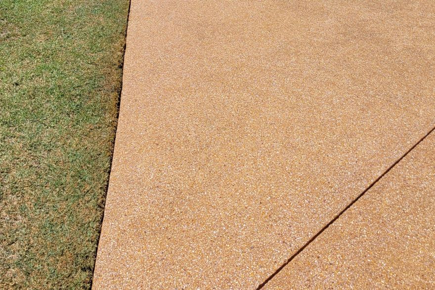 Before and after rust / bore stains on concrete exposed aggregate · Driveway: after