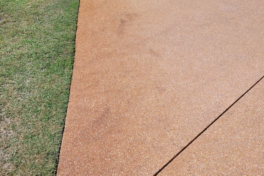 Before and after rust / bore stains on concrete exposed aggregate · Driveway: before
