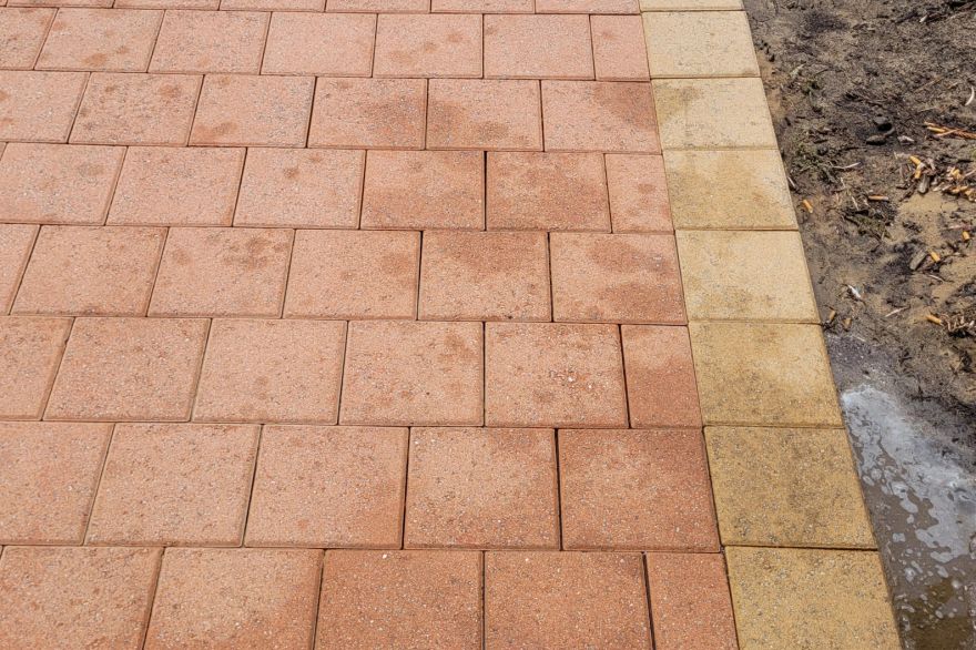 Before and after oil stains on brick pavers · Driveway: after