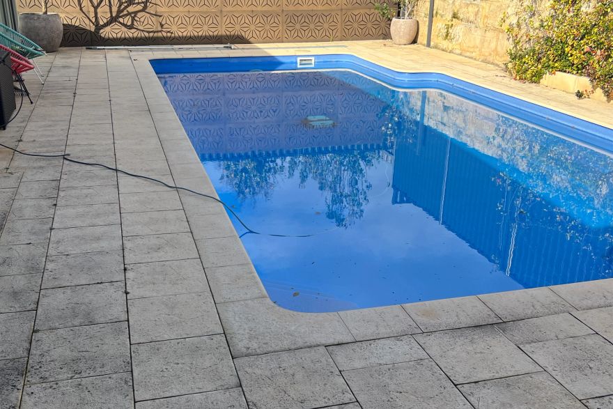 Before and after cleaning on sandstone pavers · Poolside: before
