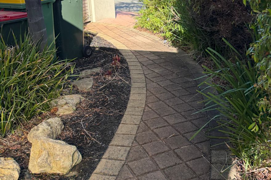 Before and after cleaning on brick pavers: before