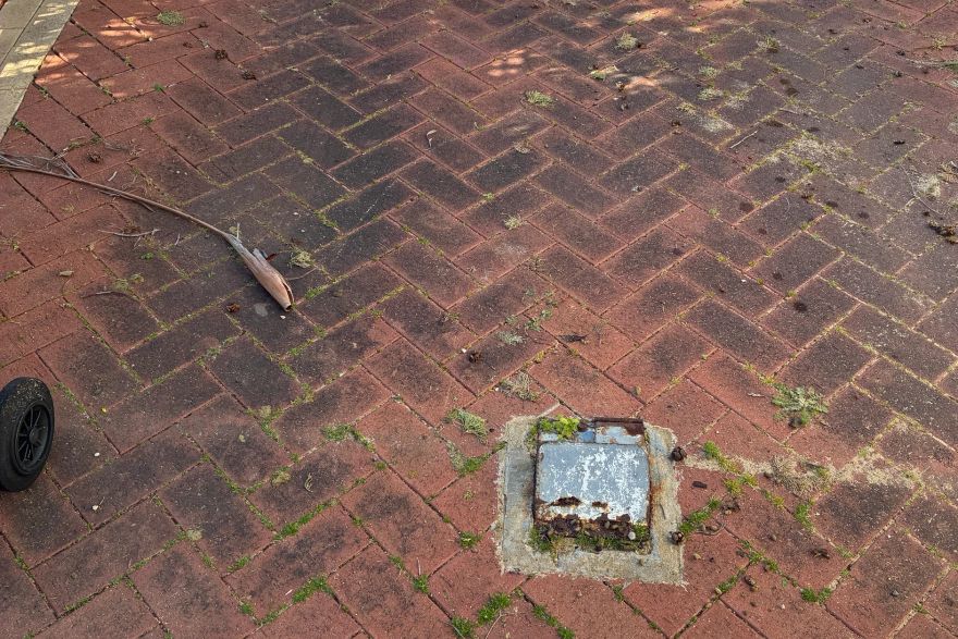 Before and after cleaning on brick pavers · Driveway: before