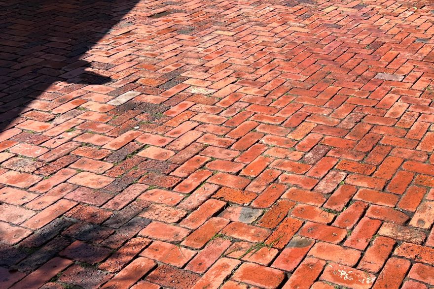 Before and after cleaning on brick pavers · Driveway: after