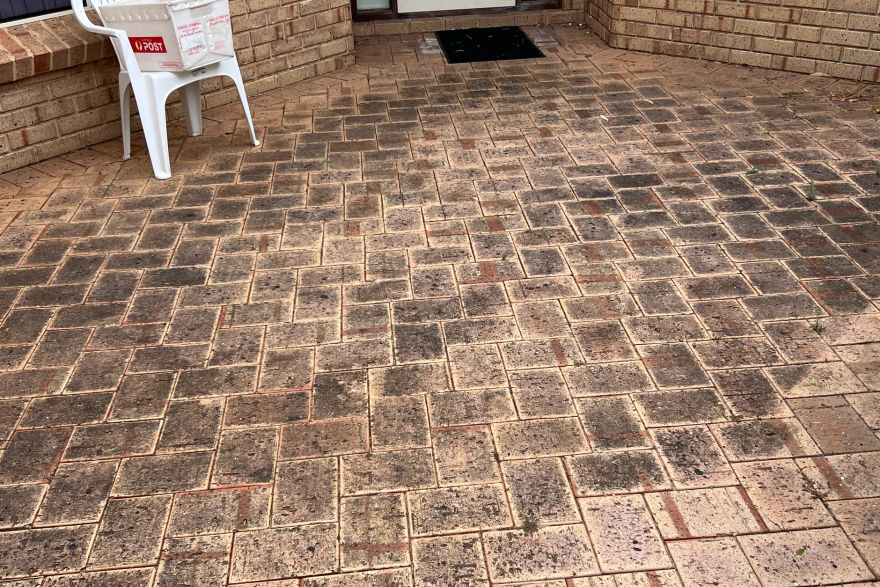 Before and after cleaning on brick pavers: before