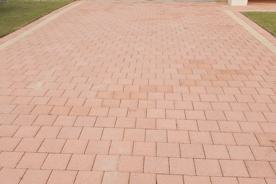 Before and after cleaning on brick pavers · Driveway: after